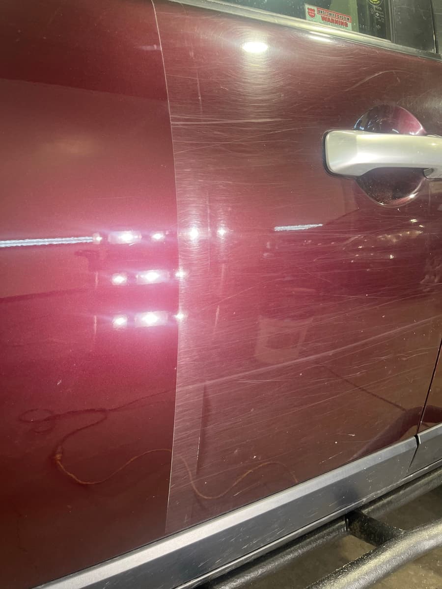Before and after paint correction showing swirl mark removal on dark paint