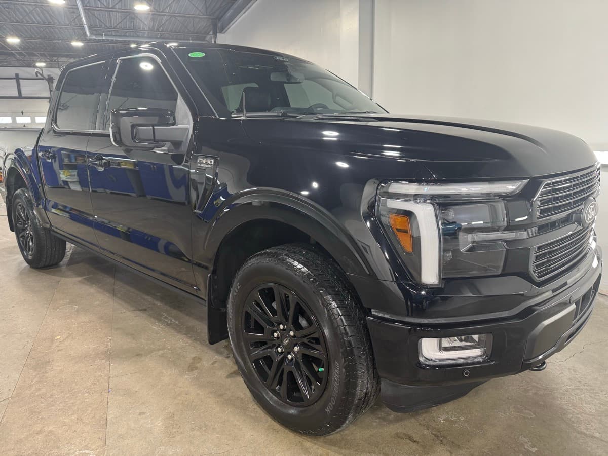 Black Ford F-150 Platinum with mirror-finish detail and custom black wheels at 2Clean Inc.