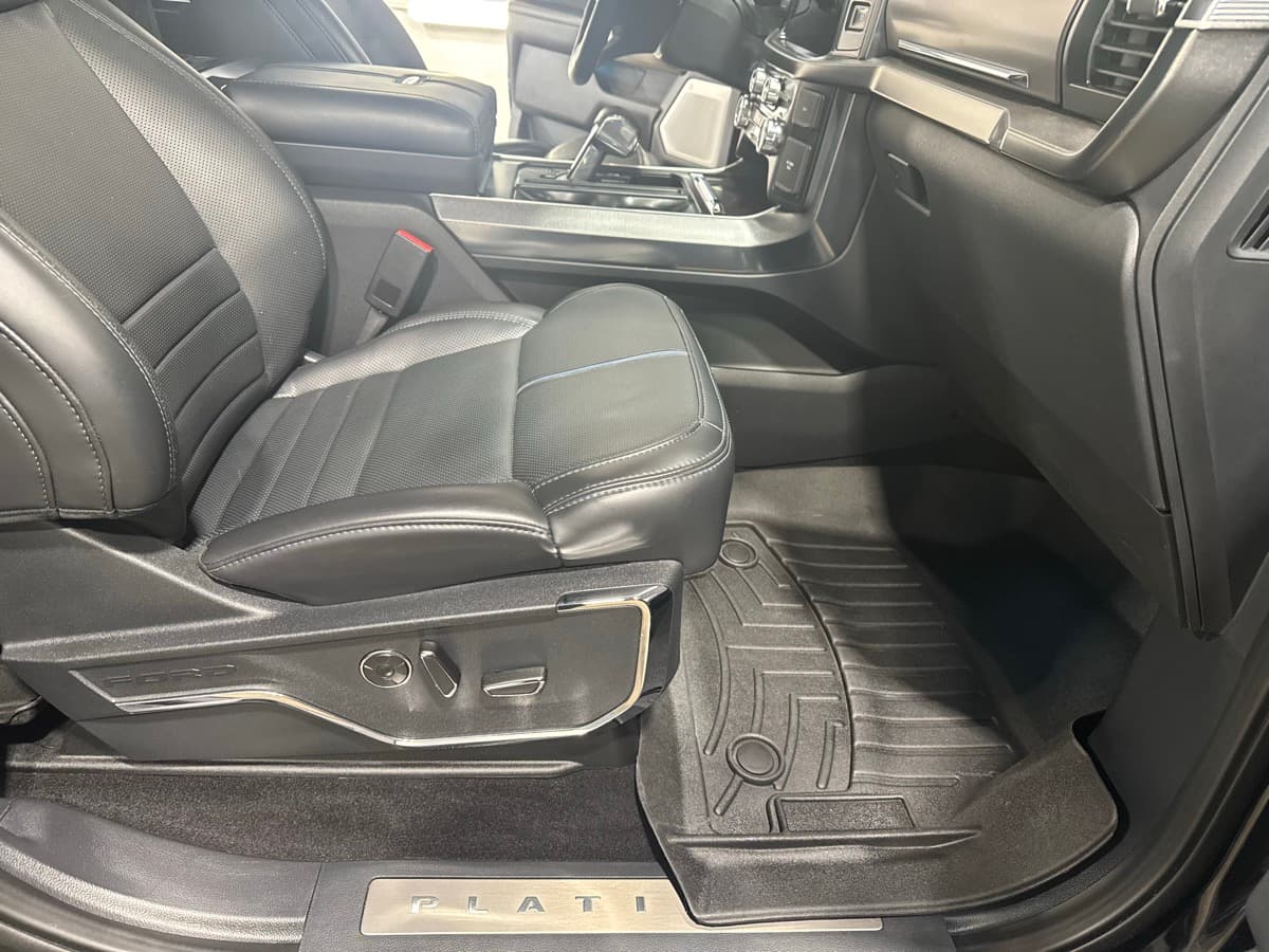 Truck cabin interior with gray leather seats and center console after full interior detail